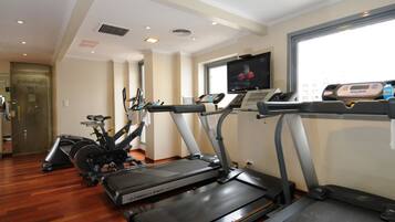 A gym with treadmills, stationary bikes, and weight machines.