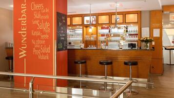 A bar area with a red pillar labeled 'Wunderbar' and multiple stools.
