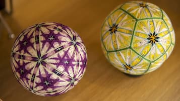 Two spherical objects with intricate patterns, placed on a wooden surface.