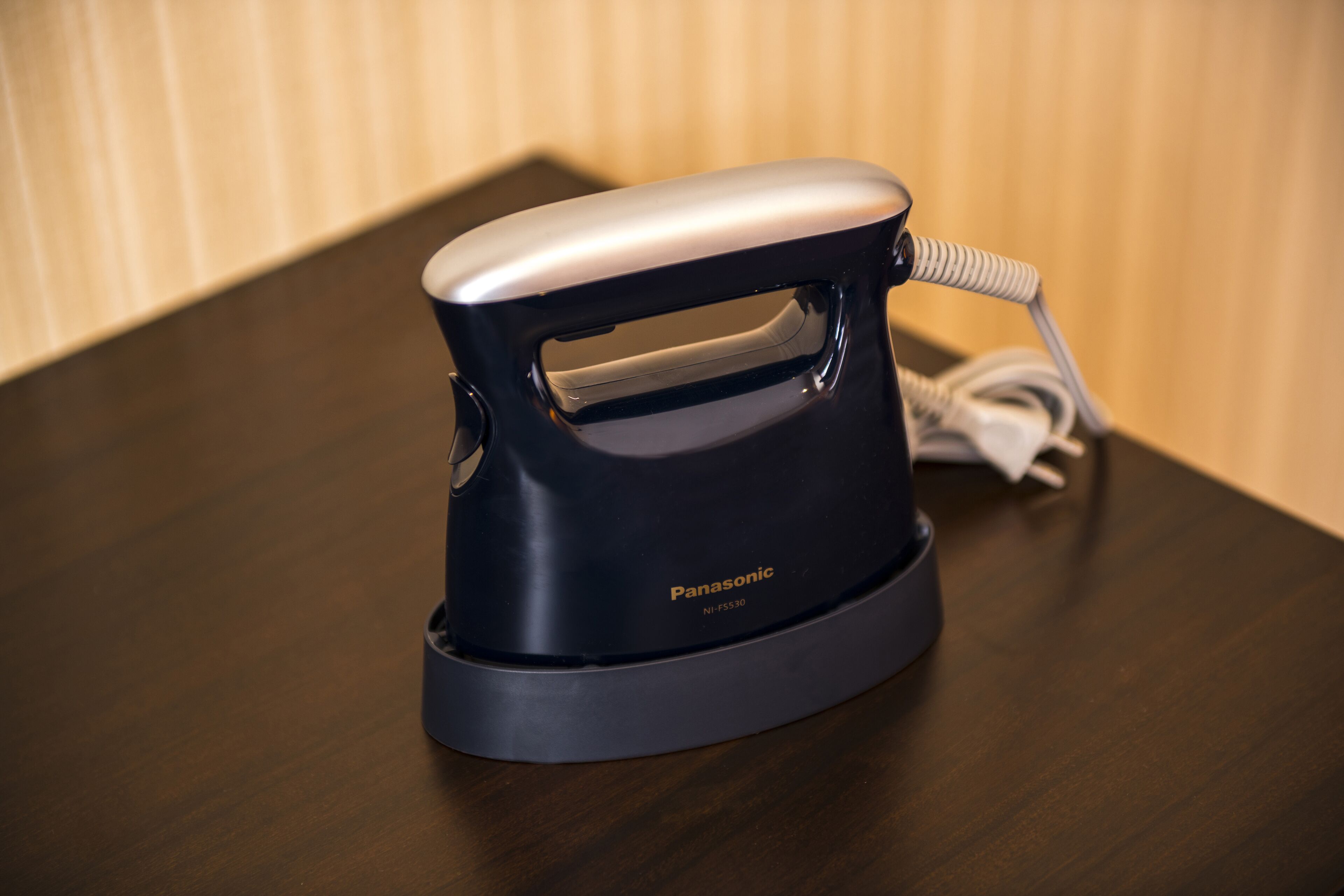 A Panasonic electric kettle on a wooden table.