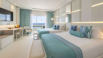 A modern hotel room with two beds, a desk, and a balcony with a view.