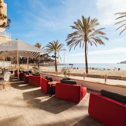 Relax in style with comfortable seating and a stunning beach view.