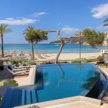 A swimming pool with a view of the beach and ocean.