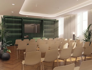 A conference room with rows of chairs, a large screen, and green paneling on the walls. - Slavia (Brno)