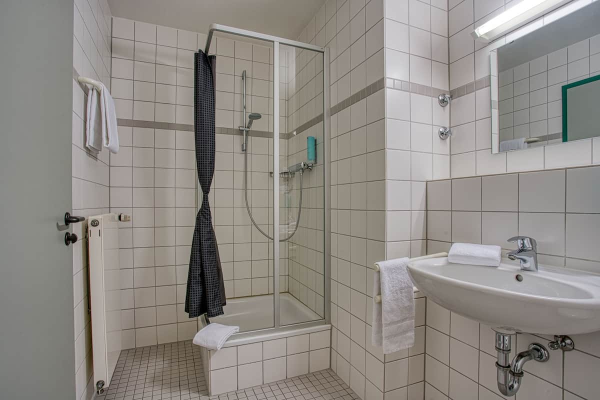 standard double room | bathroom | shower, rainfall showerhead, hair dryer, towels
