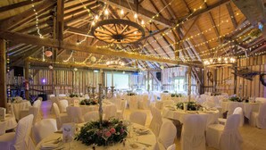 A banquet hall with round tables, white chairs, and string lights. - Hotel Bayerischer Hof Miesbach, BW Premier Collection (Miesbach)