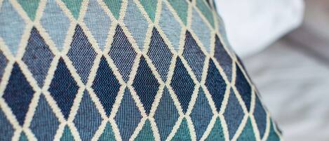 A close-up of a pillow with a diamond pattern.