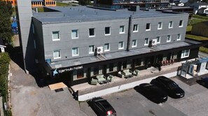 Guests can relax in the hotel's outdoor seating areas with comfortable chairs and tables.