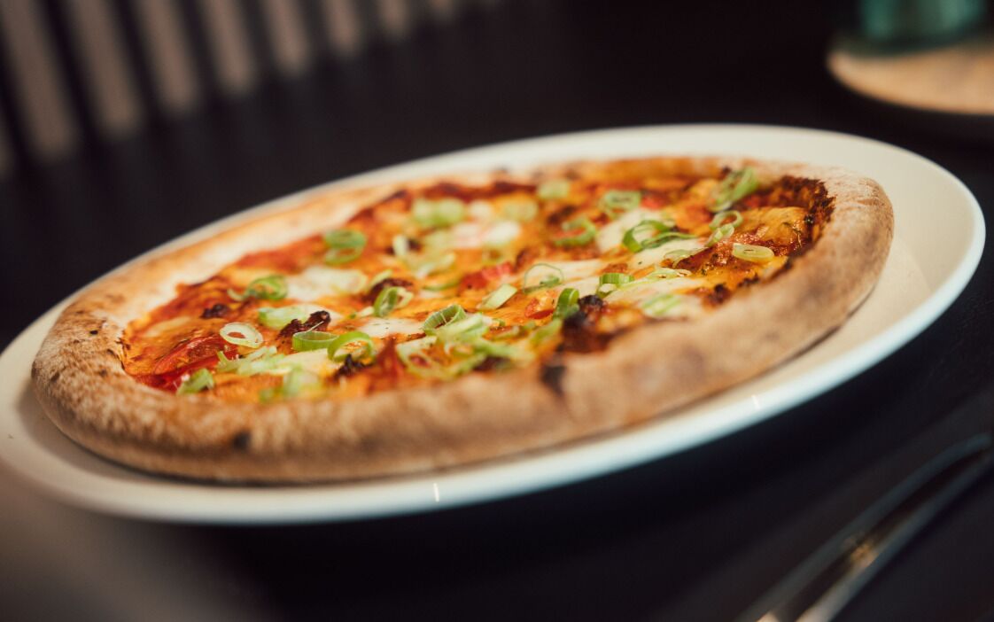A pizza on a white plate.
