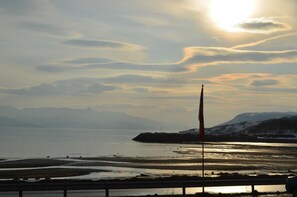 Stroll along the serene coastal promenade, taking in breathtaking views of the calm waters and distant mountains.