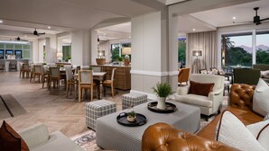 A spacious living area with a dining set, comfortable seating, and a view of the outdoors. - Protea Hotel by Marriott George King George (George)