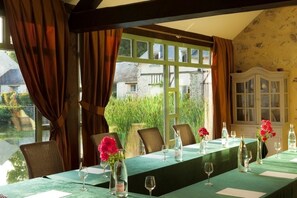 Enjoy meals in this elegant dining area with a long table, wine glasses, and beautiful vases.