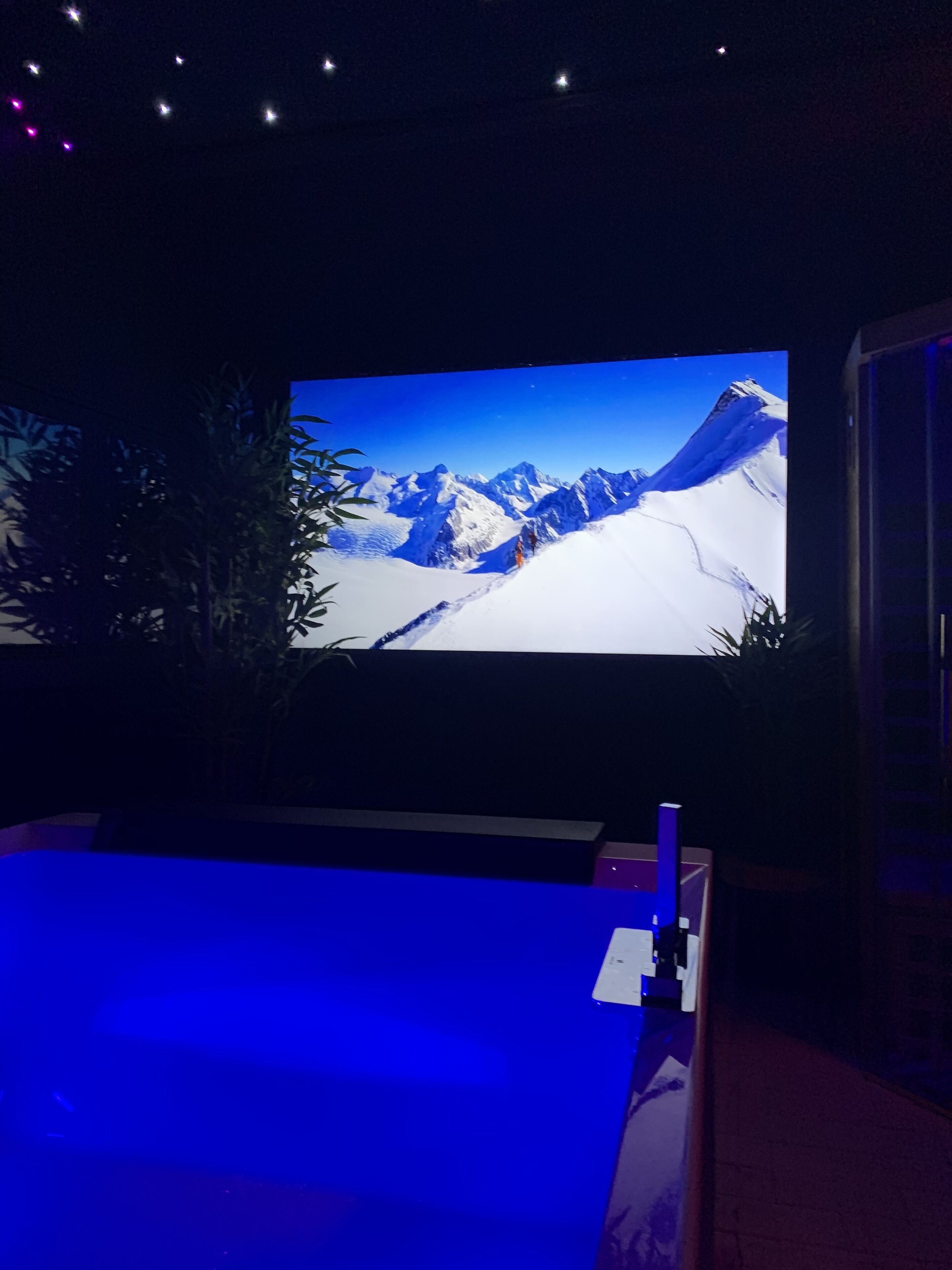 A large screen displaying a snowy mountain landscape.