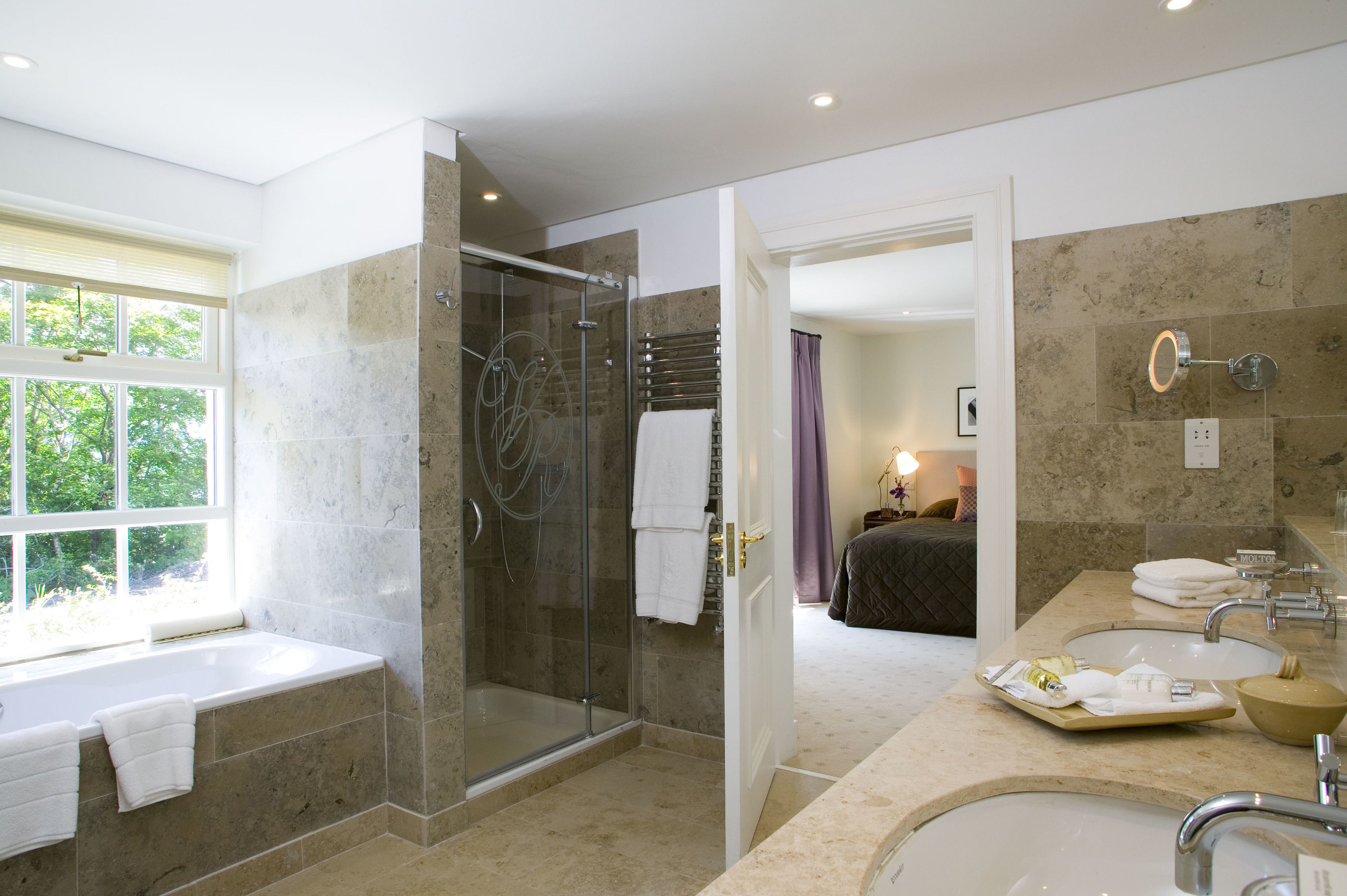combined shower/bathtub, designer toiletries, hair dryer, bathrobes