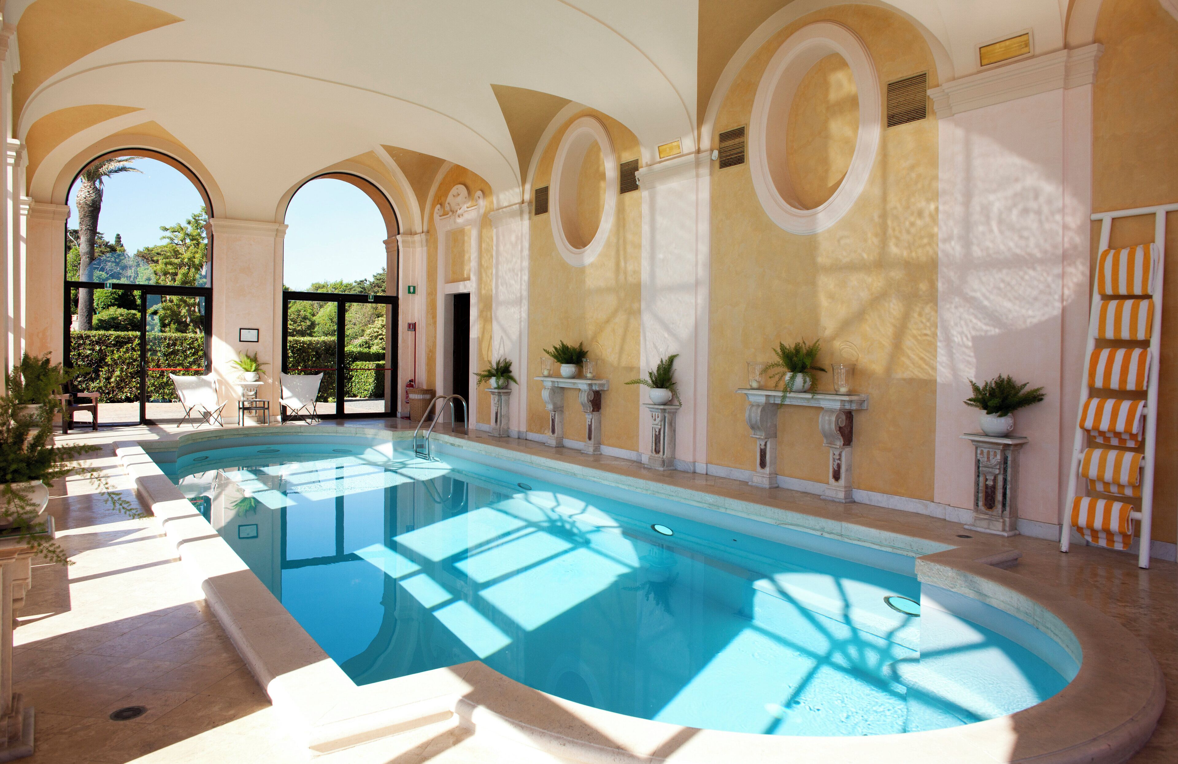 indoor pool, pool umbrellas, pool loungers