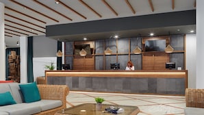 A modern reception area with a wooden reception desk, wicker furniture, and a glass coffee table.