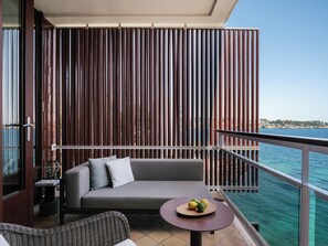 A balcony with a sofa, a small table with fruits, and a view of the sea. - Hotel de Mar Gran Meliá - The Leading Hotels of the World (Calvia)