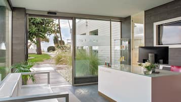 A modern spa with a reception desk, a seating area, and a view of the outdoors.