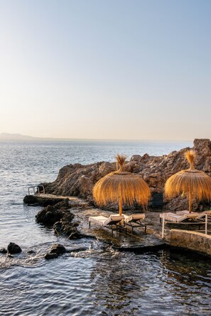 On the beach, white sand, sun loungers, beach umbrellas