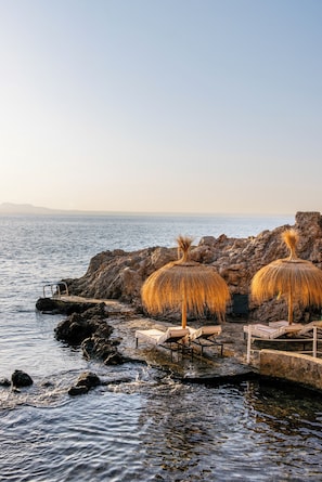 On the beach, white sand, sun loungers, beach umbrellas