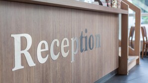 A reception desk with the word "Reception" prominently displayed.