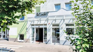 Un edificio moderno con un cartello che riporta la scritta 'ACHAT'.