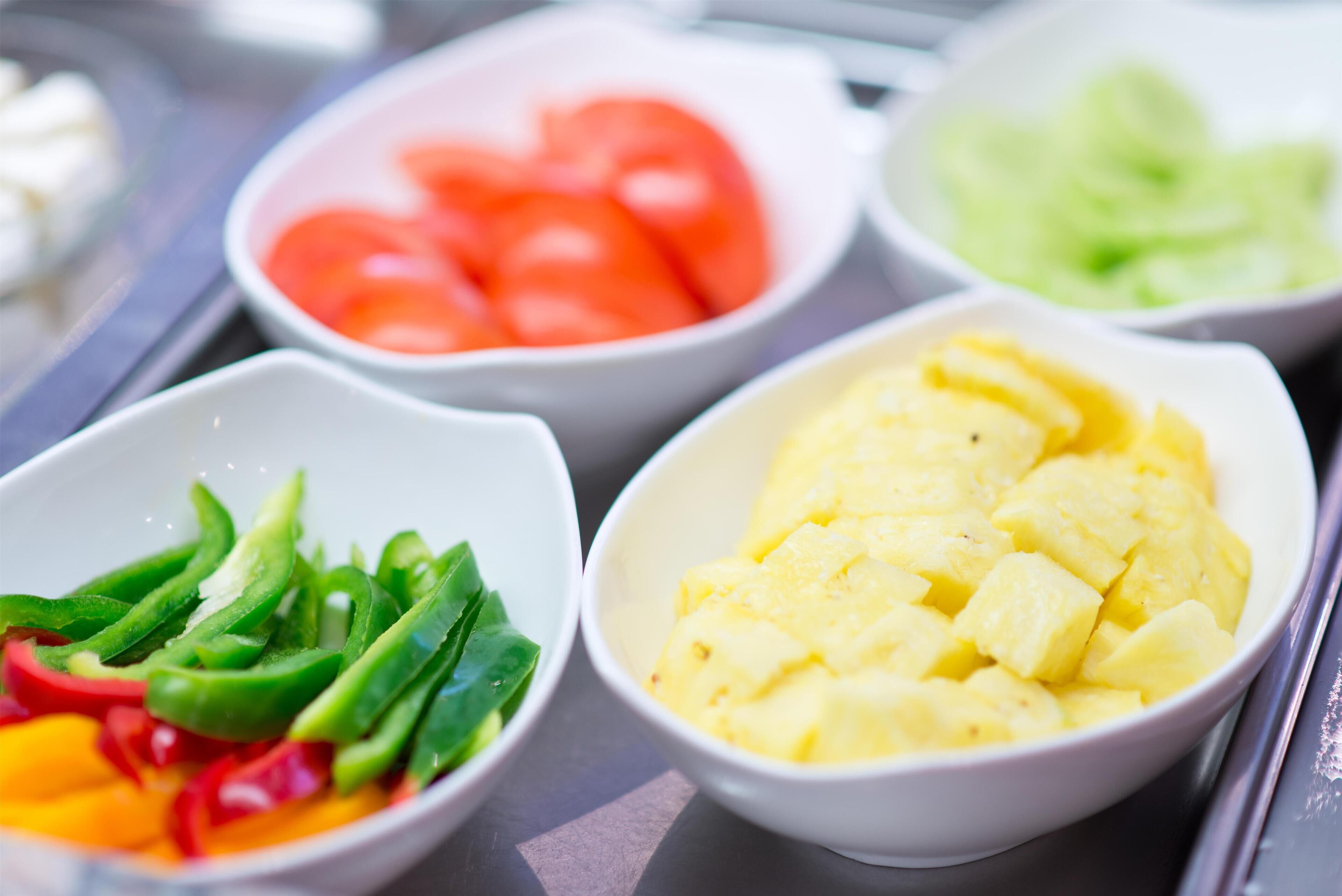 A variety of fresh fruits and vegetables in bowls.