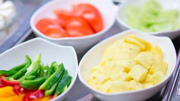 A variety of fresh fruits and vegetables in bowls.