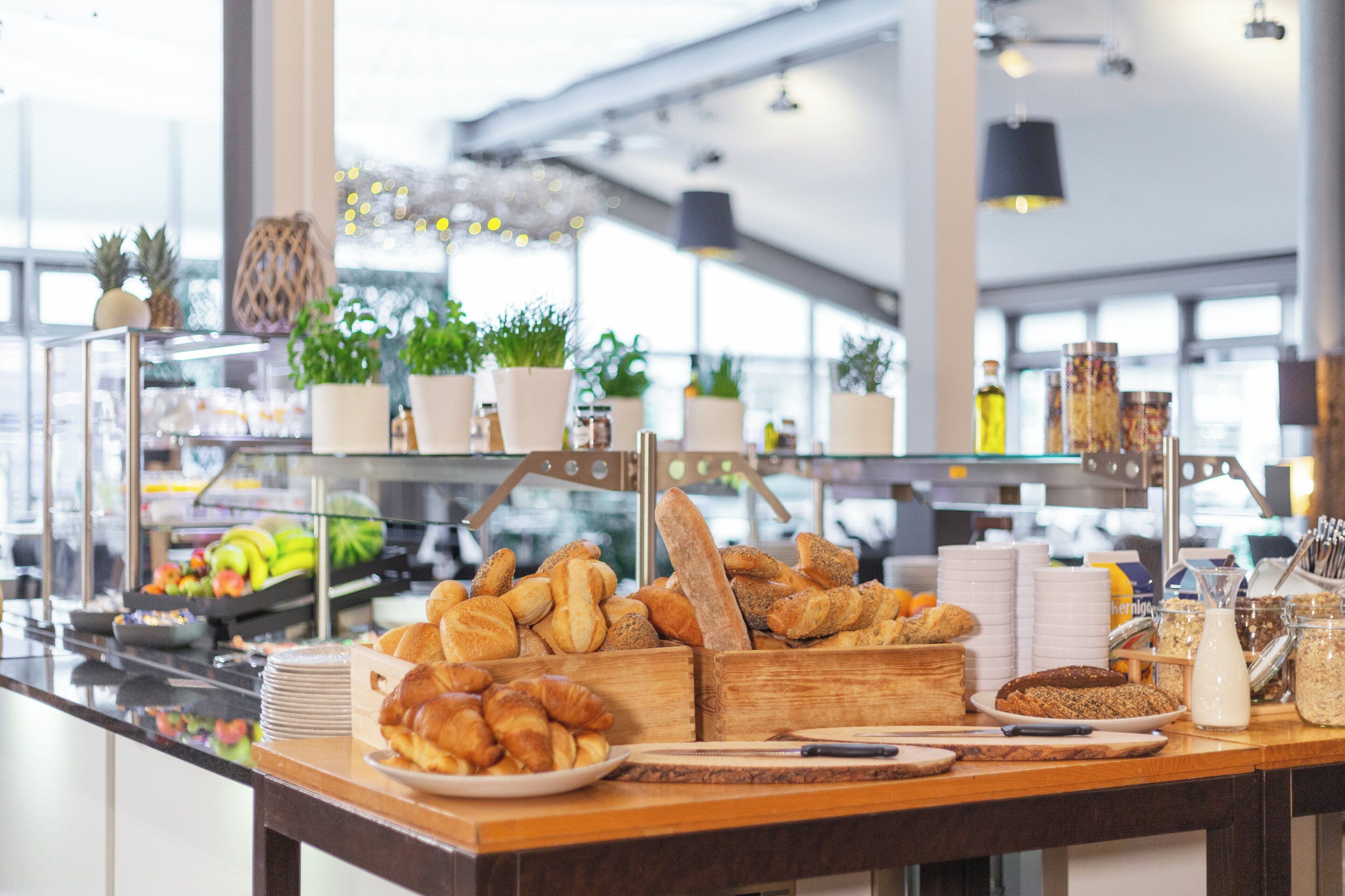 A breakfast buffet with various pastries, fruits, and beverages.