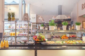 A buffet with various fruits, vegetables, and beverages. - Garner Hotel Elmshorn by IHG (Elmshorn)