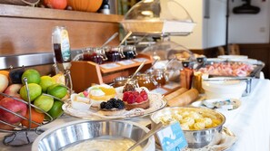A buffet with various food items including fruits, desserts, and dairy products.