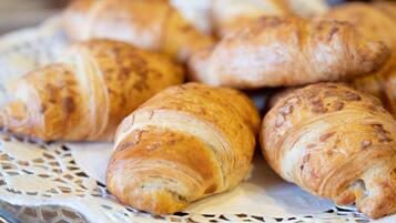 A basket of golden-brown croissants.
