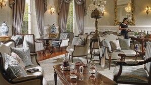 A luxurious room with elegant furniture, a chandelier, and a large mirror. - The Maryborough Hotel and Spa (Douglas)