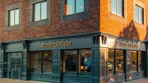 A building with a storefront labeled "ALDER CAFE BAR". - The Plaza Hotel (Dublin)