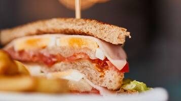 A sandwich on a plate with a toothpick.