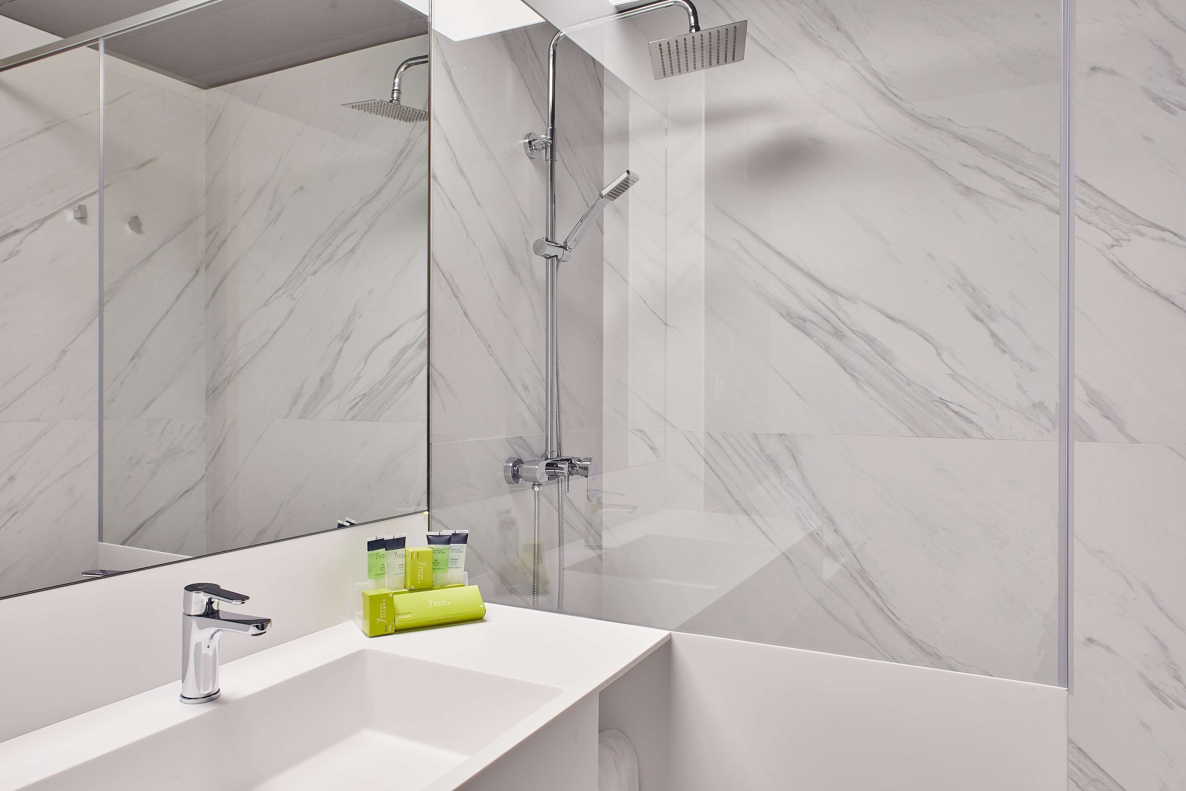 combined shower/bathtub, designer toiletries, hair dryer, towels