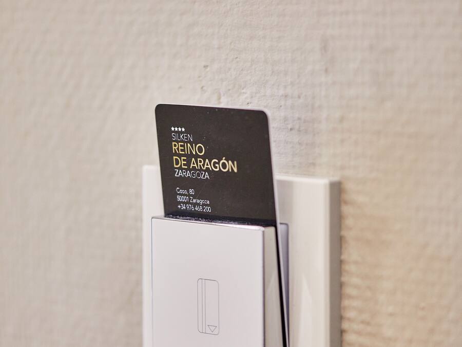A white wall-mounted device with a black card inserted into it.