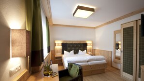 A hotel room with a wooden bed, bedside tables, a desk with a chair, and a mirror. - Hotel Bierwirt (Innsbruck)