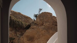 A stone staircase leading to a rocky landscape with a clear sky. - Andronikos Hotel - Adults Only (Mykonos)