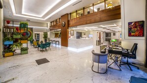 A spacious lobby with a reception desk, seating area, and a second-floor balcony. - Erboy Hotel (Istanbul)