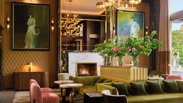 A modern interior with a fireplace, seating area, and artwork.