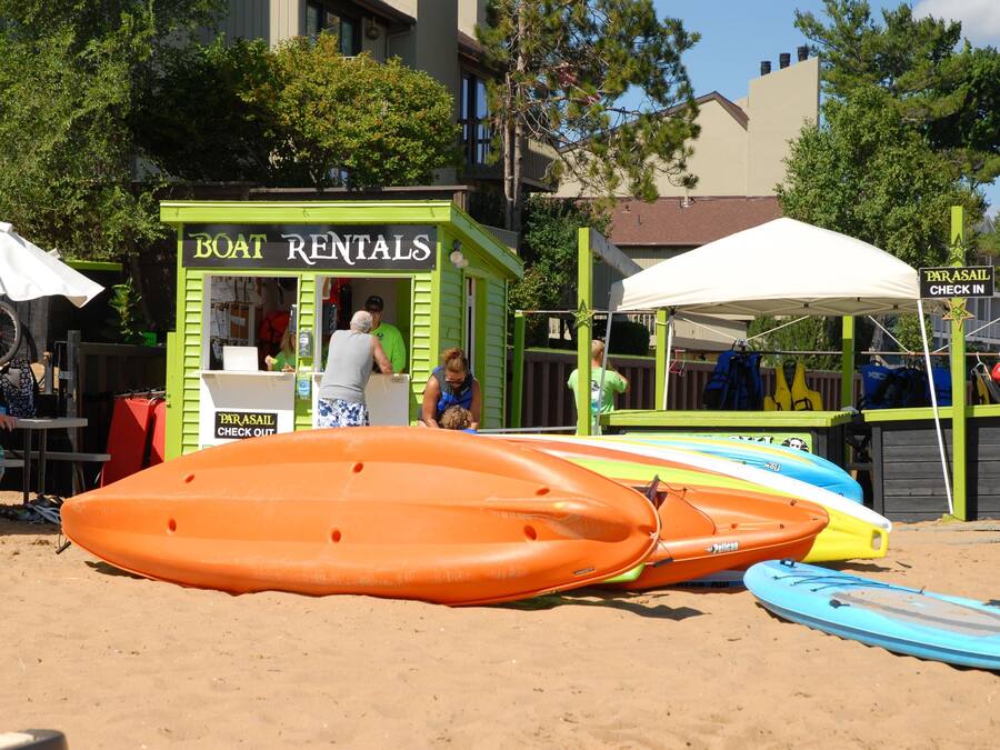A boat rental kiosk with a green exterior and a sign that reads "Boat Rentals".