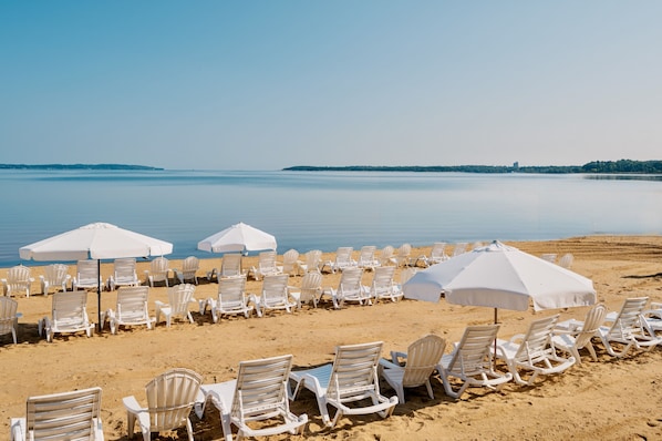 On the beach, sun-loungers, beach umbrellas, beach towels