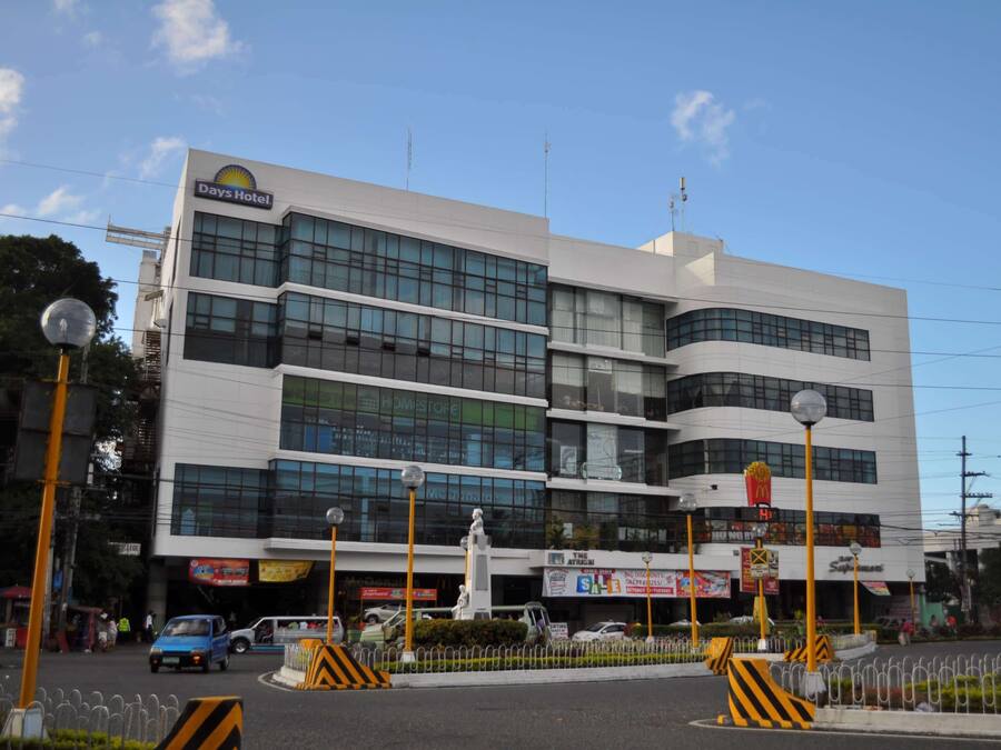 A Days Hotel building with multiple floors, large windows, and a McDonald's sign.