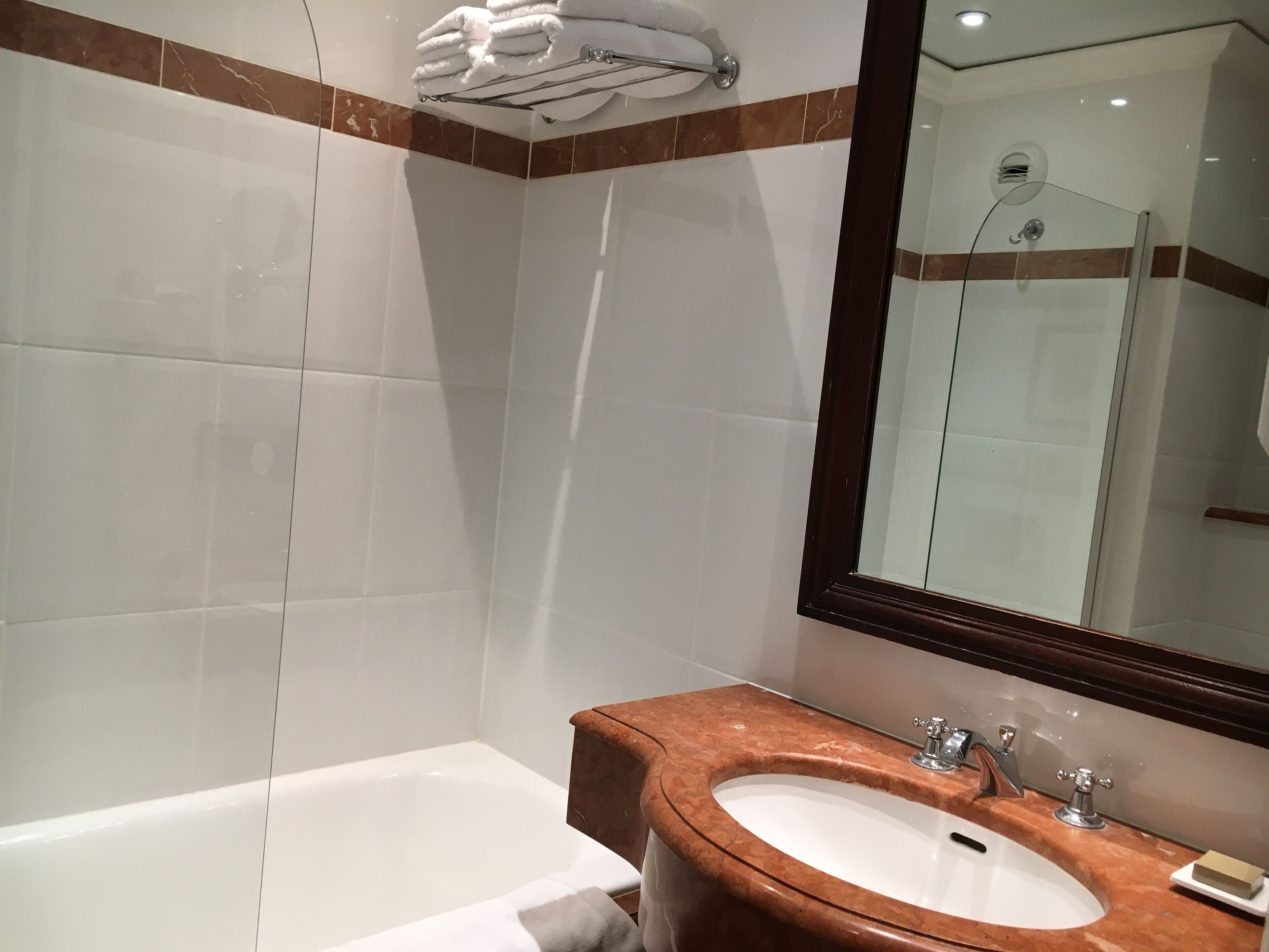 combined shower/bathtub, designer toiletries, hair dryer, towels