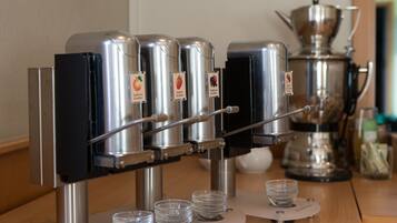 A coffee machine with multiple dispensers and a large pot, likely for brewing coffee.