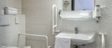 A modern bathroom with a toilet, bidet, and sink.
