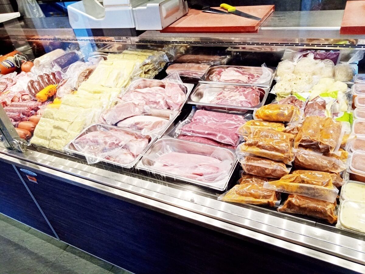 A meat display case in a grocery store with various cuts of meat.