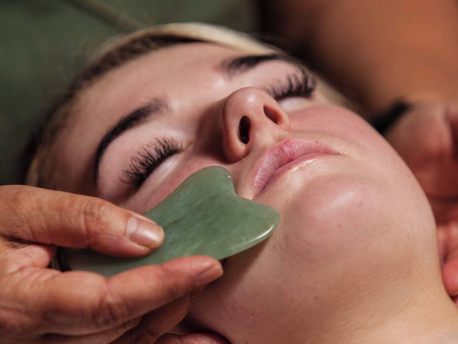 A close-up of a person receiving a facial treatment.