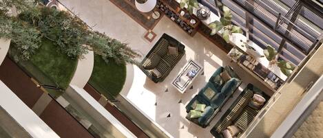 An outdoor seating area with a sofa, chairs, and a table.